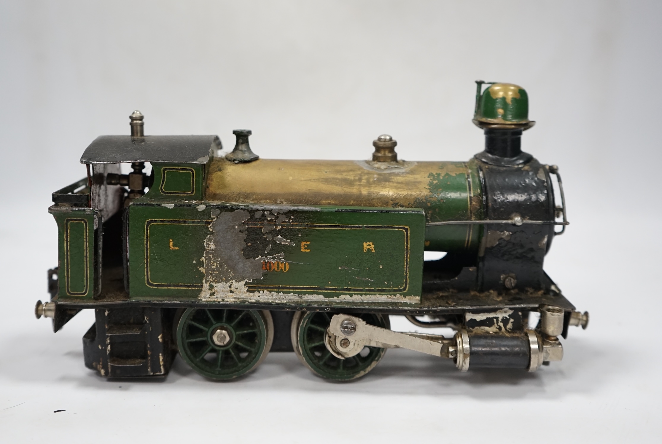 A Trix Twin Railway 00 gauge train set box containing; four locomotives, eight bogie coaches, two railcars, and six freight wagons, together with a live steam Marklin 0-4-0T LNER locomotive. Condition - poor to fair.